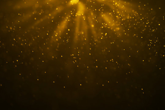 Christmas Gold Gradient Sparkle Glitter Dust Particles From Top On Black Background With Bokeh Flowing And Ray Light, Golden Holiday Happy New Year And Valentine Day Love, Relationship Concept