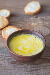 Bowl of cheese dip with toasts