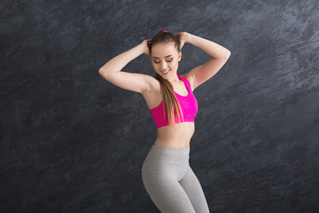 Fototapeta na wymiar Beautiful fitness girl posing on studio background