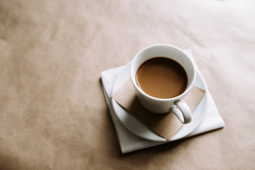 Cup of coffee over beige background.