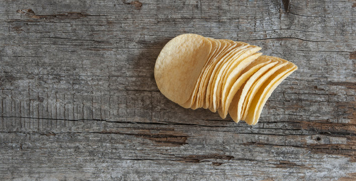 Crispy potato chips on wooden boards