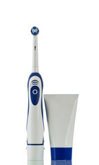 Electric toothbrush and tube of toothpaste isolated on white
