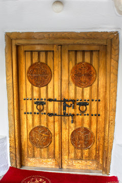 External wooden door with engraved crosses from the church of Agios Athanasios ( Santa Athanasios ) in Griva
