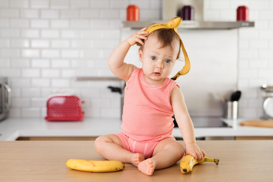 Portrait of baby boy playing with bananas