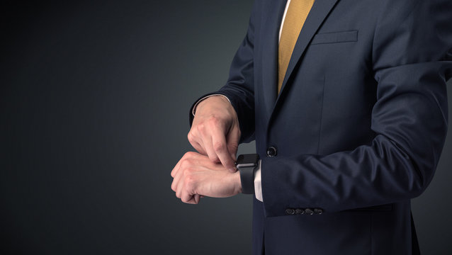 Man in suit wearing smartwatch.