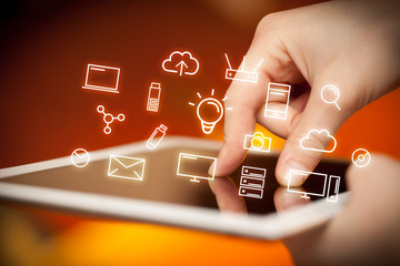Fingers touching tablet with icons