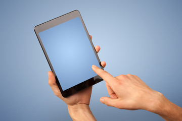 Female hand holding tablet