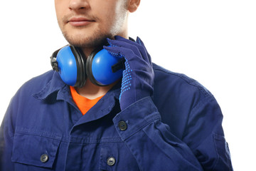 Male worker with headphones on white background. Hearing protection equipment