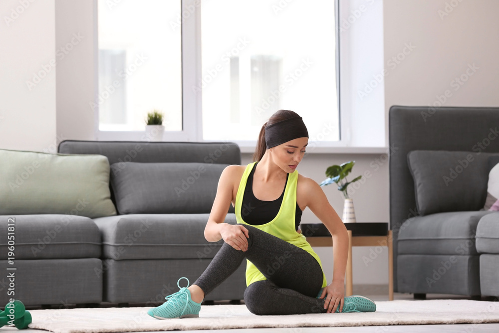 Poster Beautiful young woman doing fitness exercise at home