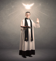 young priest in giving his blessing