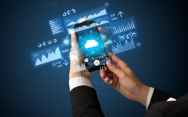 Hand using phone with financial tracking concept