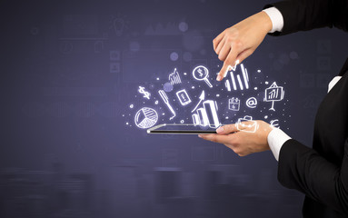 Hand holding tablet with chalk drawn symbols above