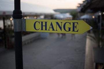 Street signboard "Change" on a blurred background. Concept: Time to change, Change the Way, Time for improvment or a place to exchange money.