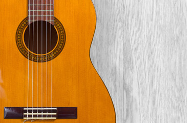 Fototapeta premium Classical Guitar over a Wooden Texture