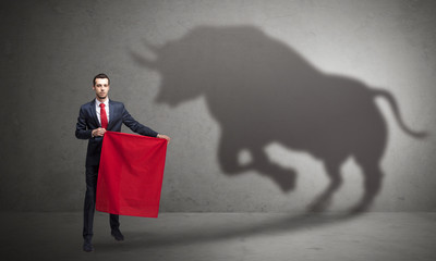 Businessman with bull shadow and toreador concept
