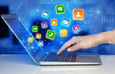 Hand using laptop with bouncing application graphs and report concept