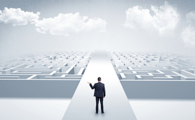 Businessman going straight on two mazes