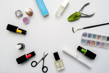 Bottles of nail polish on a colorful wooden table