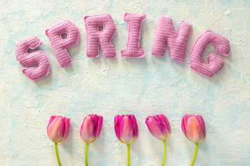tulip floweres and spring word from knitted letters