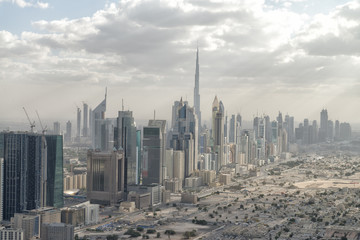 Fototapeta na wymiar DUBAI, UAE - DECEMBER 10, 2016: Aerial city skyline from helicopter. Dubai attracts 20 million people annually