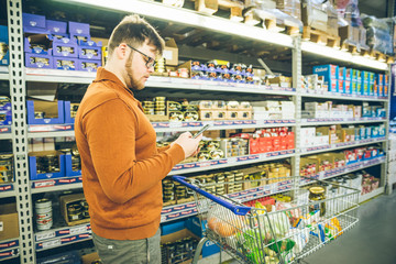 man check buy list on phone.