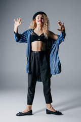 Young beautiful female dancer is posing in the studio
