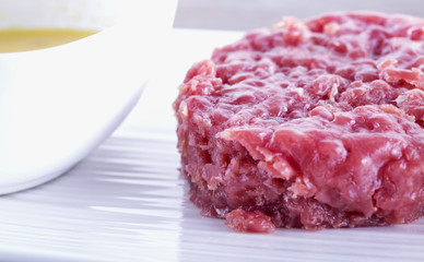 Raw meat over white plate