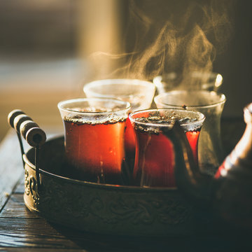 Freshly brewed black tea in turkish glasses in oriental tray, selective focus, copy space, square crop