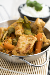 Roast fried meat in a stainless steel pan with rice and vegetables