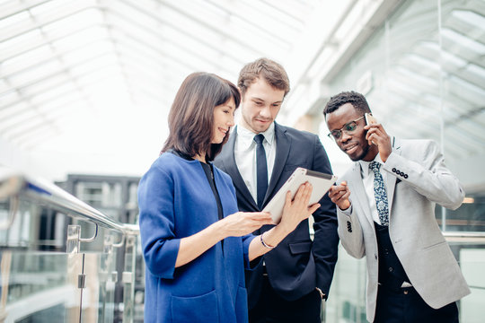 Multiracial Business people using digital tablet on meeting, female boss showing presentation on tablet