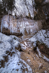 hanging icicles on rocks at the mountain lake