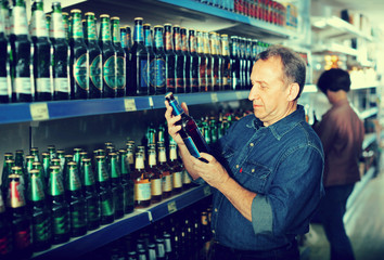 European selecting a beer at the grocery store