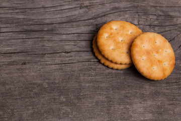 Biscuit cracker yellow round on old wooden background. Copy space for text