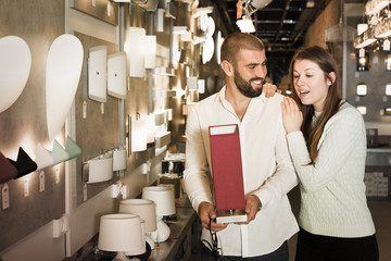 family looking night-light in the furniture store