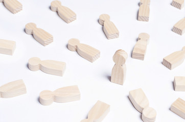 A person is in the spotlight. A wooden figure of a man. Concept business idea. Best in the business. People lie around. Victory, progress, innovation.