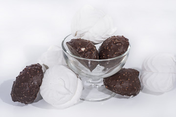 Black and white marshmallows in glassware.