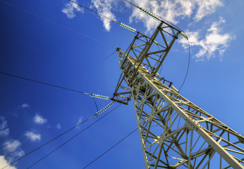 High voltage electrical overhead line on blue sky