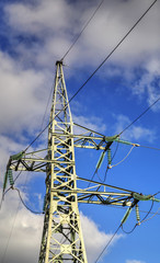 High voltage electrical overhead line on blue sky