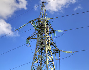 High voltage electrical overhead line on blue sky