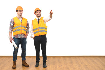 The two engineers gesture on the white wall background