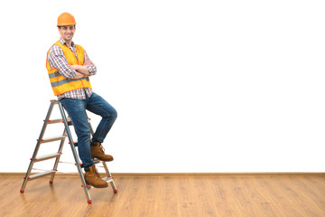 The builder standing on the ladder on the white wall background