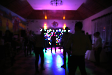 Blurry background, people at dance party,