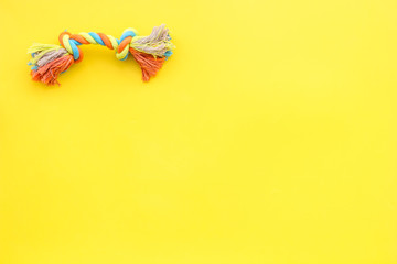 grooming equipment with brushes and toys for care and training pet yellow background top view mock up