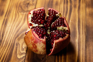 Ripe pomegranate fruit on wooden table