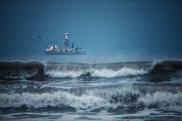International Container Cargo ship in the sea water after sunset. Freight Transportation, Shipping, Nautical Vessel