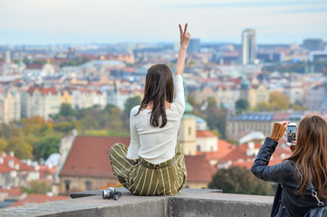 Prague, Czech Republic - October 10, 2017: Pretty Asian girl poses and looks at the old city of...