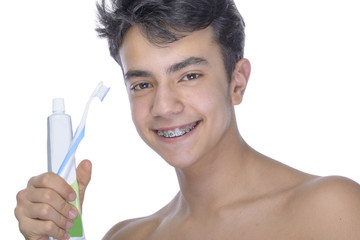 Teen boy wearing braces on white background