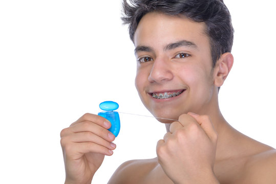 Teen boy wearing braces on white background