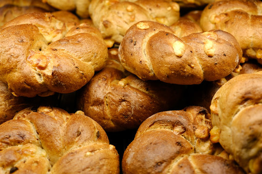 Freshly baked rolls with grains close-up photo background