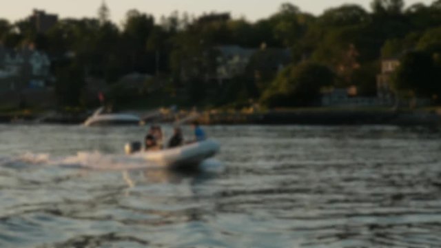 Slow motion teenagers riding on a motor boat